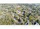Aerial view of neighborhood with tree coverage, homes, and a pond at 0000 Se 17Th Ct, Ocala, FL 34471