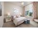 Charming bedroom with pink bed, floral curtains, ceiling fan, and natural light at 0000 Se 17Th Ct, Ocala, FL 34471