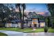 Stunning home showcasing manicured landscaping and a charming stone accented entry at 0000 Se 17Th Ct, Ocala, FL 34471