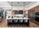 Modern kitchen features a large island, stainless steel appliances, and stylish pendant lighting at 0000 Se 17Th Ct, Ocala, FL 34471