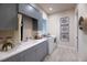 Functional laundry room featuring gray cabinets, ample counter space, and modern appliances at 0000 Se 17Th Ct, Ocala, FL 34471