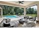 Inviting covered outdoor living space featuring a pool and comfortable seating area at 0000 Se 17Th Ct, Ocala, FL 34471