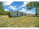 The backyard features a well-maintained lawn and offers ample space for outdoor activities and relaxation at 10435 Se 125 Ln, Belleview, FL 34420