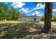 Home exterior with ample green space, shade trees, and plenty of room for outdoor activities and relaxation at 10435 Se 125 Ln, Belleview, FL 34420