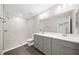 Bathroom featuring double vanity, modern fixtures, and a walk-in shower with glass doors at 10435 Se 125 Ln, Belleview, FL 34420