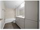 Well-lit bathroom with modern vanity, new fixtures, tub, tiled shower, and built in storage at 10435 Se 125 Ln, Belleview, FL 34420