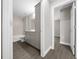 Well-lit bathroom with modern vanity, new fixtures, tub, and tiled shower, plus wood-look flooring at 10435 Se 125 Ln, Belleview, FL 34420