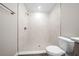 Newly renovated bathroom with a tiled shower, a modern toilet, and stylish fixtures throughout at 10435 Se 125 Ln, Belleview, FL 34420