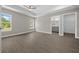 Large bedroom with plenty of natural light, vinyl flooring, and access to a walk-in closet and a bathroom at 10435 Se 125 Ln, Belleview, FL 34420