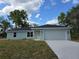 Charming single-story home with a well-manicured lawn and a two-car garage, perfect for suburban living at 10435 Se 125 Ln, Belleview, FL 34420