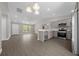 Open-concept kitchen featuring stainless steel appliances, quartz countertops, and wood-look flooring with natural light at 10435 Se 125 Ln, Belleview, FL 34420