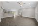 Large living room featuring an open floor plan, light gray floors and access to the kitchen at 10435 Se 125 Ln, Belleview, FL 34420