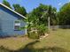 The backyard is beautifully landscaped with tropical plants and features a garden area at 1069 Se 57Th Ave, Ocala, FL 34480
