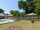 This backyard showcases a pool with chairs, a lush green lawn and manicured landscaping at 1069 Se 57Th Ave, Ocala, FL 34480