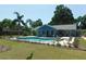 Backyard featuring a pool with lounge chairs and lush landscaping at 1069 Se 57Th Ave, Ocala, FL 34480
