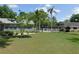 Lush lawn with mature trees and palms offer a relaxing view at 1069 Se 57Th Ave, Ocala, FL 34480