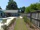 Landscaped backyard with seating area, manicured lawn, and privacy fence, creating a peaceful outdoor space at 1069 Se 57Th Ave, Ocala, FL 34480