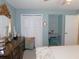 Airy bedroom features a built-in desk, closet, and vintage furniture at 1069 Se 57Th Ave, Ocala, FL 34480