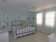 Inviting bedroom with a ceiling fan, comfortable bed, and plenty of natural light streaming through the large windows at 1069 Se 57Th Ave, Ocala, FL 34480
