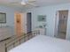 Bedroom featuring neutral walls, a comfortable bed, bedside tables, and an ensuite bathroom area off to the side at 1069 Se 57Th Ave, Ocala, FL 34480