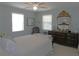 Inviting bedroom with a vintage mirror, serene paint, and comfortable furnishings at 1069 Se 57Th Ave, Ocala, FL 34480