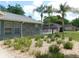 This home boasts a beautifully landscaped yard with decorative stone and lush greenery at 1069 Se 57Th Ave, Ocala, FL 34480