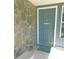 Inviting blue front door with a textured stone wall providing great curb appeal at 1069 Se 57Th Ave, Ocala, FL 34480