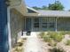 Charming stone accented front entrance with a cozy bench and attractive landscaping at 1069 Se 57Th Ave, Ocala, FL 34480