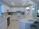Well-lit kitchen with white appliances, tile countertops, and a functional layout with bar seating at 1069 Se 57Th Ave, Ocala, FL 34480
