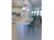 Kitchen bar area with seating and pendant lighting, leading into a cozy living room at 1069 Se 57Th Ave, Ocala, FL 34480