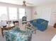 Bright living room featuring carpet, and comfortable seating near the front entry at 1069 Se 57Th Ave, Ocala, FL 34480