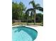 Backyard pool area featuring diving board, manicured lawn, and privacy landscaping, creating an inviting outdoor space at 1069 Se 57Th Ave, Ocala, FL 34480