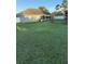 Inviting backyard with a covered patio and lush green lawn, ideal for relaxing and entertaining at 10999 Sw 47Th Ave, Ocala, FL 34476