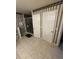 Unique bathroom featuring tiled floor, decorative wallpaper, glass-doored shower and double doors at 10999 Sw 47Th Ave, Ocala, FL 34476