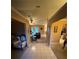 Inviting foyer with tile flooring leading to a cozy living area and kitchen at 10999 Sw 47Th Ave, Ocala, FL 34476