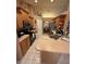Functional kitchen with wooden cabinets and a breakfast bar overlooking the dining area at 10999 Sw 47Th Ave, Ocala, FL 34476