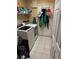Functional laundry room with modern washer and dryer, and convenient shelving at 10999 Sw 47Th Ave, Ocala, FL 34476