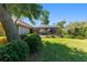 Backyard with mature landscaping leads to screened-in pool area at 1103 Se 46Th St, Ocala, FL 34480