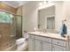 Bathroom with granite counters, tiled shower and glass door for a sleek and modern design at 1103 Se 46Th St, Ocala, FL 34480