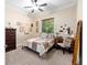 Comfortable bedroom with neutral tones, a full sized bed, dresser, desk, and carpet flooring; creating a relaxing retreat at 1103 Se 46Th St, Ocala, FL 34480
