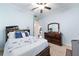 Inviting bedroom features light blue walls, a full sized bed with a white comforter, and dark wood furniture at 1103 Se 46Th St, Ocala, FL 34480