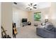 This bedroom offers a comfortable space with neutral carpet, a ceiling fan and a large window at 1103 Se 46Th St, Ocala, FL 34480