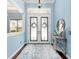 Elegant entryway with hardwood floors, a decorative mirror, and a view into the living spaces at 1103 Se 46Th St, Ocala, FL 34480