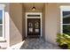 Inviting entryway featuring double doors, a 'Welcome' mat, and an elegant light fixture at 1103 Se 46Th St, Ocala, FL 34480