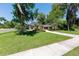Well-manicured front yard leading to a cozy home featuring a two-car garage and tidy landscaping at 1103 Se 46Th St, Ocala, FL 34480