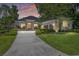 Beautiful single-story home featuring manicured landscaping, a stone facade, and a spacious driveway at 1103 Se 46Th St, Ocala, FL 34480