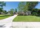 Charming single-story home with a well-maintained lawn and complemented by lush landscaping at 1103 Se 46Th St, Ocala, FL 34480