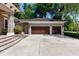 Spacious two-car garage with a wide driveway and mature trees at 1103 Se 46Th St, Ocala, FL 34480