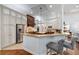 Gourmet kitchen featuring granite countertops, stainless steel appliances, custom cabinetry, and a breakfast bar with seating at 1103 Se 46Th St, Ocala, FL 34480