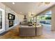 Outdoor lanai features a fireplace, tv, kitchen area and view of the pool and fountain at 1103 Se 46Th St, Ocala, FL 34480